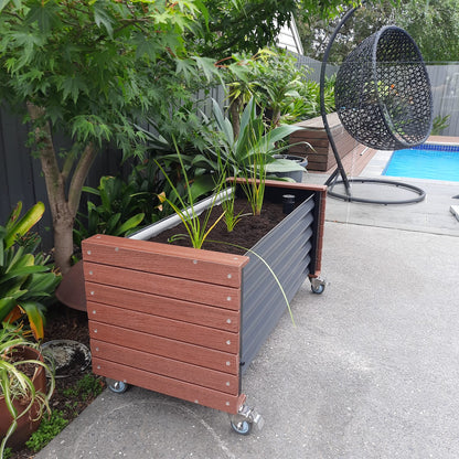 Artesian Range Eco Board Wicking Planter Box installed in a lush garden setting, showcasing its sustainable WaterUps technology, eco-friendly design with 92% recyclable materials, and water-saving benefits ideal for balconies, courtyards, and outdoor spaces